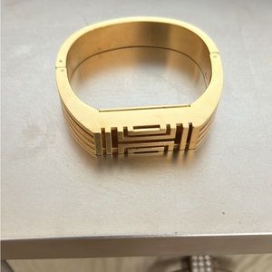 Tory Burch fit bit bracelet. Gold tone   Bangle with side clasp.  Very pretty.
